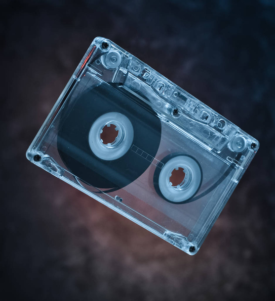 Audio cassette levitation. Retro media technology from the 80s. Mystical light. - Photo, Image
