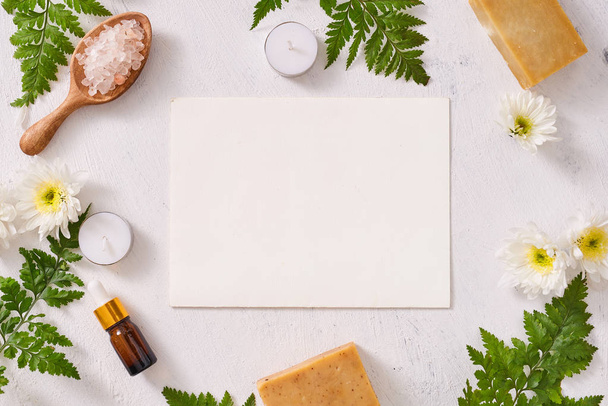 Bathroom salt, soap and aroma oil for spa on white background top view mock-up - 写真・画像