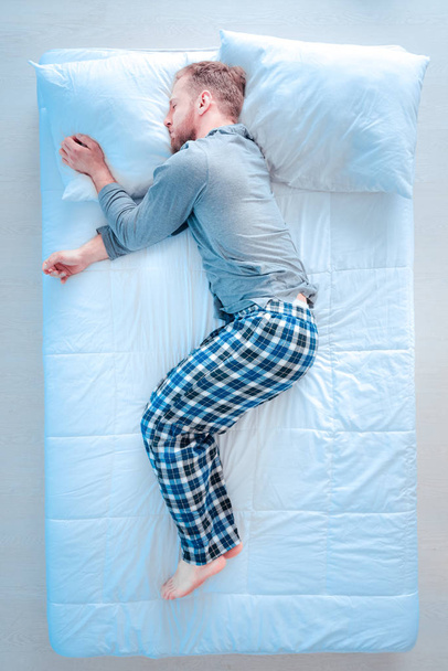 Tired man lying in embryo pose - Valokuva, kuva