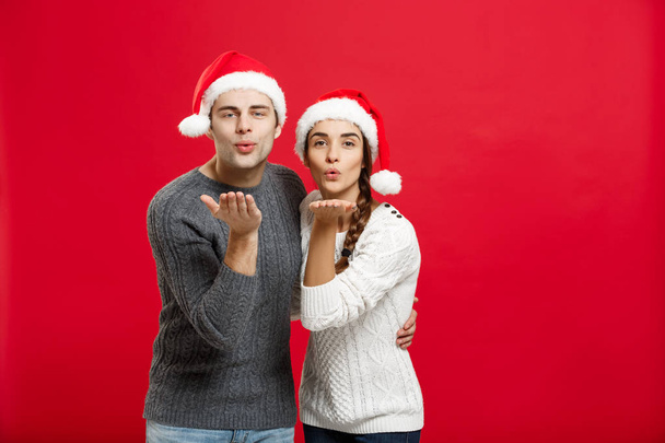 Weihnachts-Konzept - Porträt Schönes Paar bläst Wunsch zur Kamera am Weihnachtstag - Foto, Bild