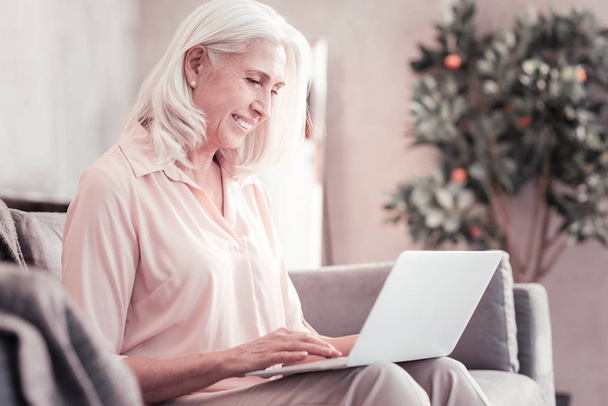 Senior cute woman spending time with using the laptop. - Foto, imagen