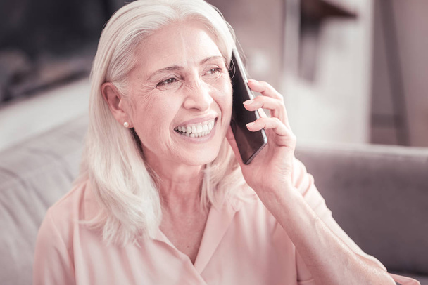 Satisfied aged woman having conversation and laughing. - Valokuva, kuva