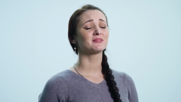 Young sad woman cry over white background - Video