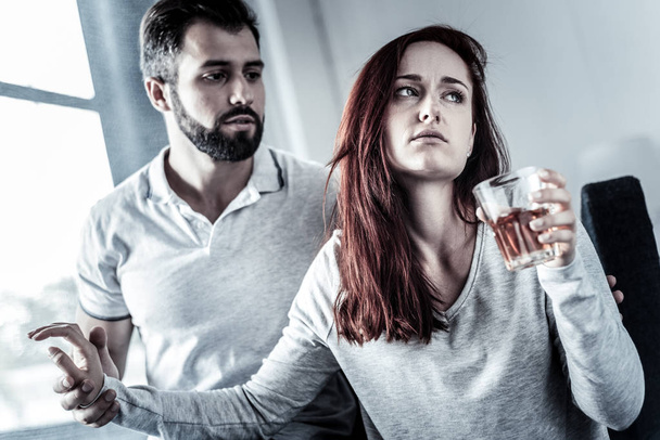 Stressful frustrated woman drinking and turning away from husband. - Fotoğraf, Görsel