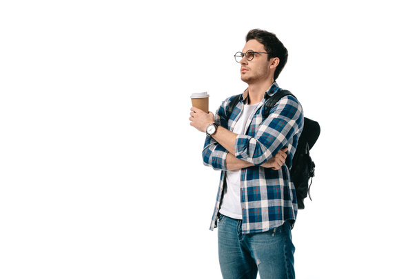 estudante bonito segurando café no copo de papel e olhando para longe isolado no branco
 - Foto, Imagem