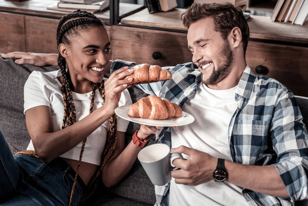 Cheerful positive woman feeding her boyfriend - Valokuva, kuva