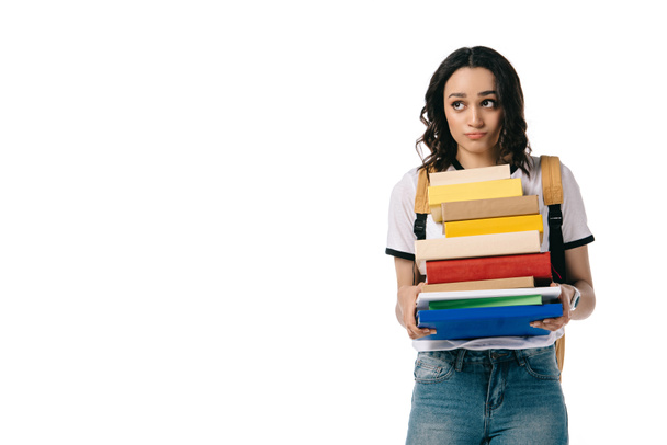 pensativo afroamericano adolescente estudiante celebración pila de libros aislado en blanco
 - Foto, Imagen