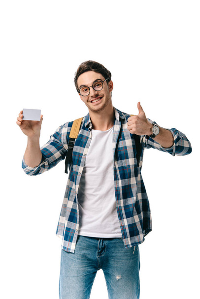 handsome student holding credit card and showing thump up isolated on white - Fotoğraf, Görsel