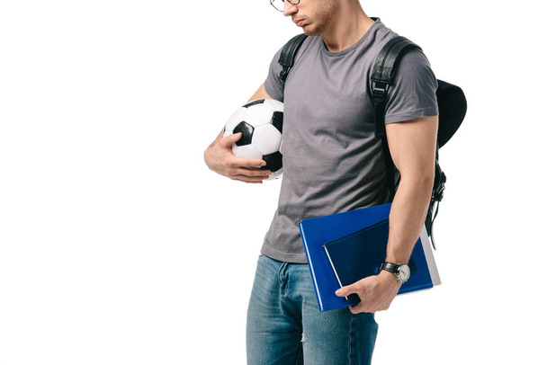 oříznutého obrazu studenta drží fotbalový míč izolované na bílém - Fotografie, Obrázek