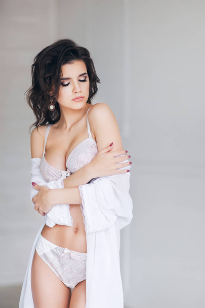 young beautiful woman posing in white sexy lingerie - Фото, зображення