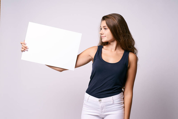 Girl with poster. White background. Template - Foto, immagini