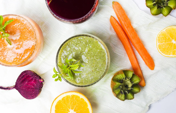 Colorful juices with ingredients on a table - 写真・画像