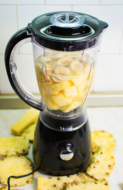 Blender ready for making pineapple banana smoothie - Foto, imagen