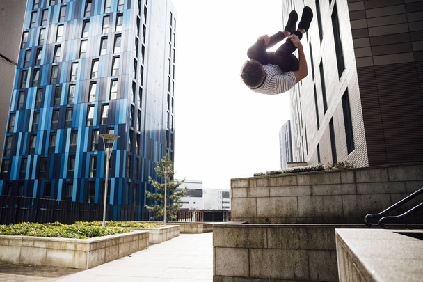 Freerunner Doing Flips in the City - Fotoğraf, Görsel
