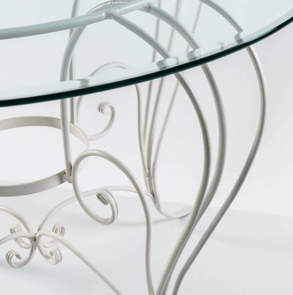Beautiful curved ornaments of wrought iron. Detail of table with - Fotografie, Obrázek