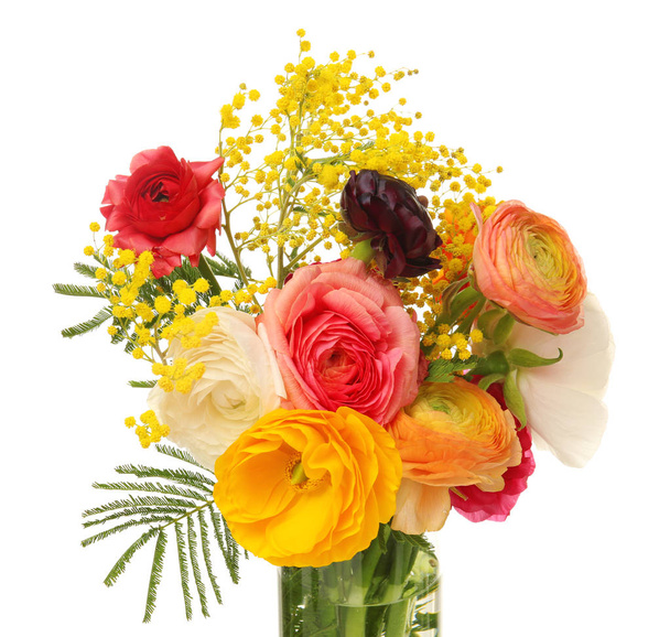 Vase with beautiful ranunculus and mimosa flowers on white background - 写真・画像