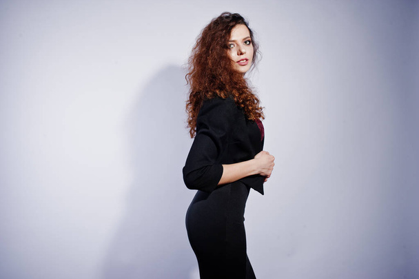 Brunette curly haired girl in black office jacket with skirt, on - Foto, Bild