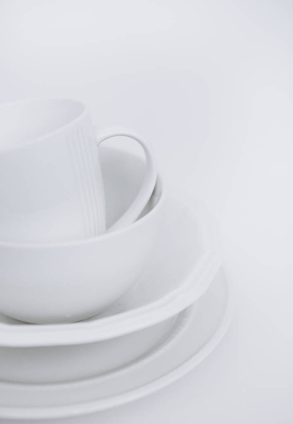 three white plates cup white background - Foto, afbeelding