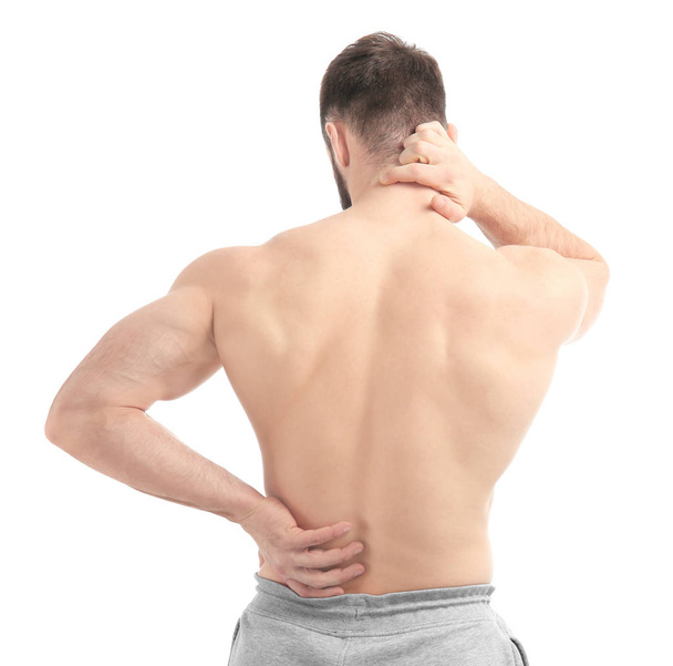 Young man suffering from back pain on white background - Φωτογραφία, εικόνα