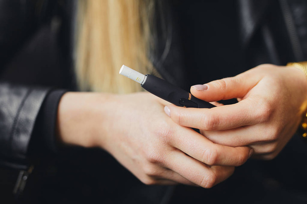 Close up electronic cigarette with case and blur girl - 写真・画像