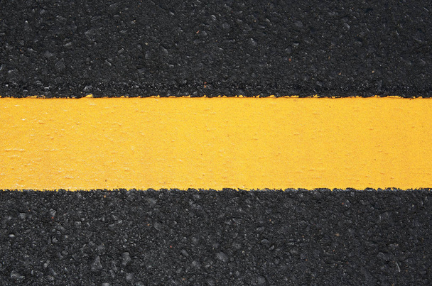 Asphalt road texture with yellow stripe - Фото, изображение
