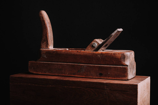 block plane tool on wooden box isolated on black - Foto, immagini