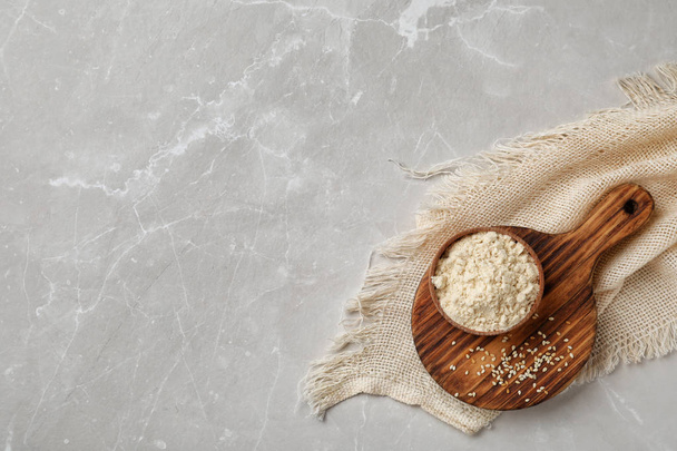 Bowl with sesame flour on light background - Φωτογραφία, εικόνα