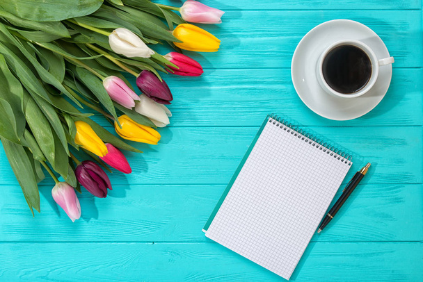 Spring background!A bouquet colorful tulips and an empty notebook for romantic entries - Photo, image