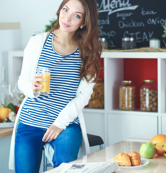 Portrait of a pretty woman holding glass with tasty juice - 写真・画像