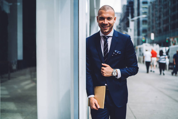 Portrait of cheerful male lawyer  in elegant formal suit standing on urban settings background, cheerful prosperous executive manager satisfied with career in corporation looking at camera outdoor - Photo, Image
