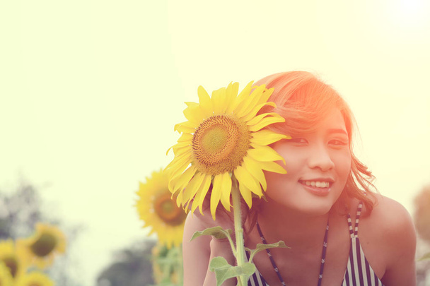Beautiful sexy woman with sunflower in sunflower fields smile at - Photo, Image