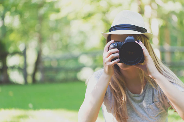 Female photographer with a camera outside - Фото, зображення