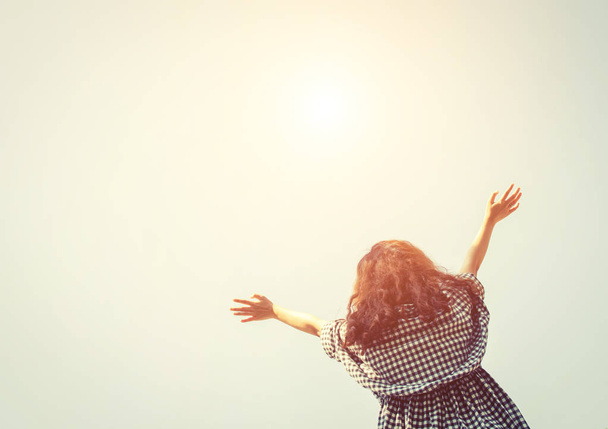Молода жінка піднімає руки в небо зі схід сонця так свіжо
. - Фото, зображення