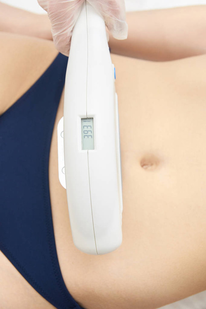 Elos Laser stomach Hair Removal. Epilation Treatment In Cosmetic Beauty Clinic - 写真・画像