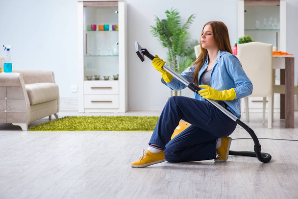 Młoda kobieta sprzątanie podłogi w domu robi prace domowe - Zdjęcie, obraz