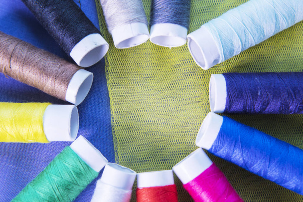Colorful threads above silk fabric - Zdjęcie, obraz
