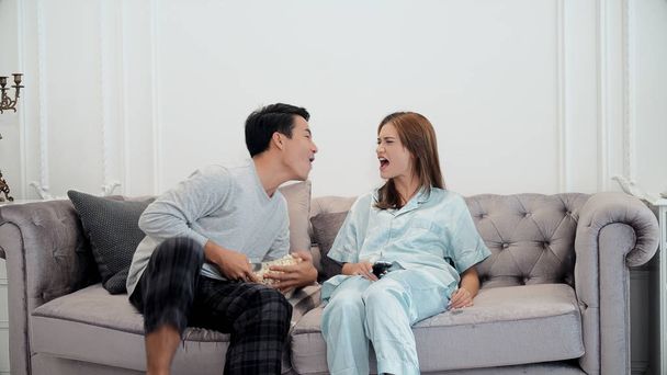 Young couple enjoy to watching television and use remote control - Foto, Bild