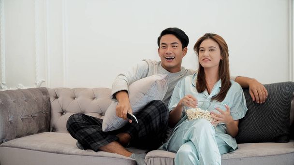 Young couple enjoy to watching television and use remote control - Foto, immagini