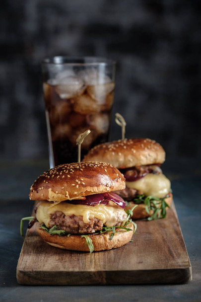 Homemade juicy burgers with beef, cheese and caramelized onions. - Photo, Image
