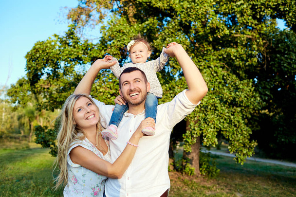 Happy family in a park in summer autumn.  - Foto, Imagen
