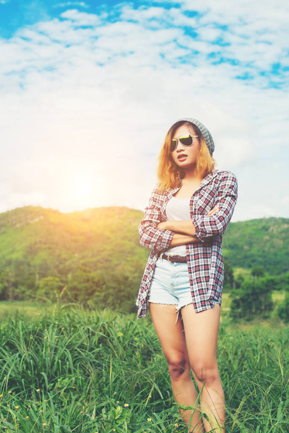 Young beautiful hipster woman standing crossed arms amidst natur - Photo, Image