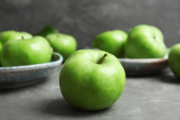 Fresh green apples on grey table - Fotografie, Obrázek