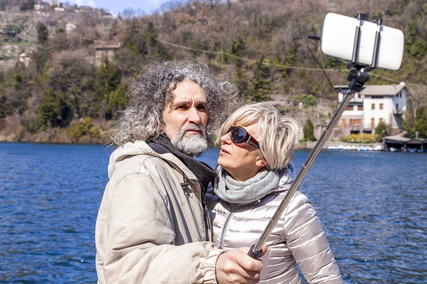 beautiful mature couple takes a selfie on the dock - Foto, immagini