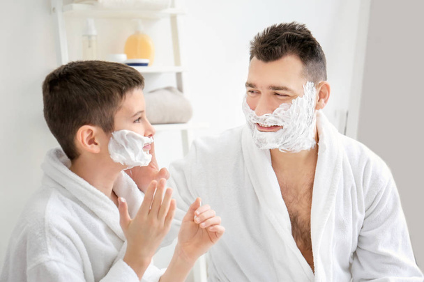 Dad teaching his son to shave in bathroom - 写真・画像