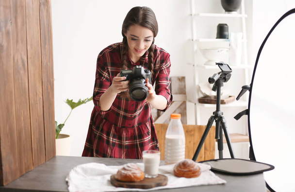 Young woman with professional camera taking food photo in studio - Valokuva, kuva