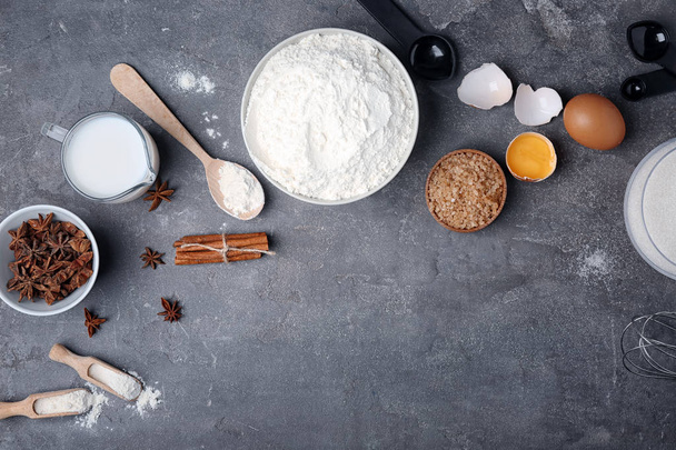 Flat lay composition with flour, eggs and jug of milk on grey background - Valokuva, kuva