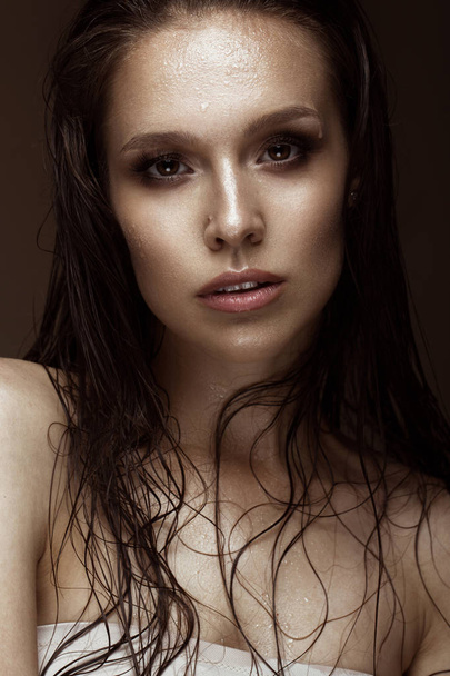 Beautiful girl with a bright make-up, wet hair and skin. Beauty face. - Fotó, kép