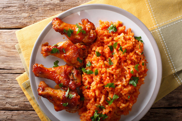 Porcion of African Jollof rice with fried chicken wings close-up - Photo, Image