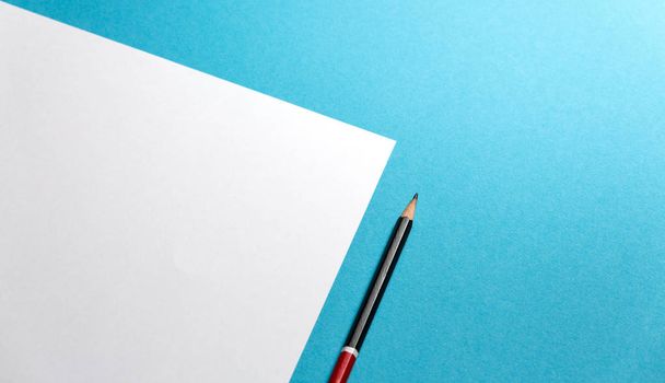 Pencil Lies On A Paper Sheet On Blue Background With Copy-Space. Office Space Creativity Minimalism Concept - Photo, image