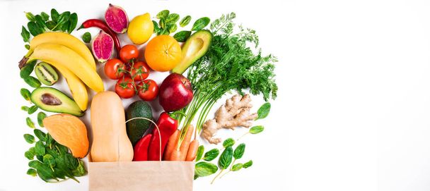 Healthy food background. Healthy vegetarian food in paper bag fruits and vegetables on white background. Shopping food supermarket concept - Photo, Image